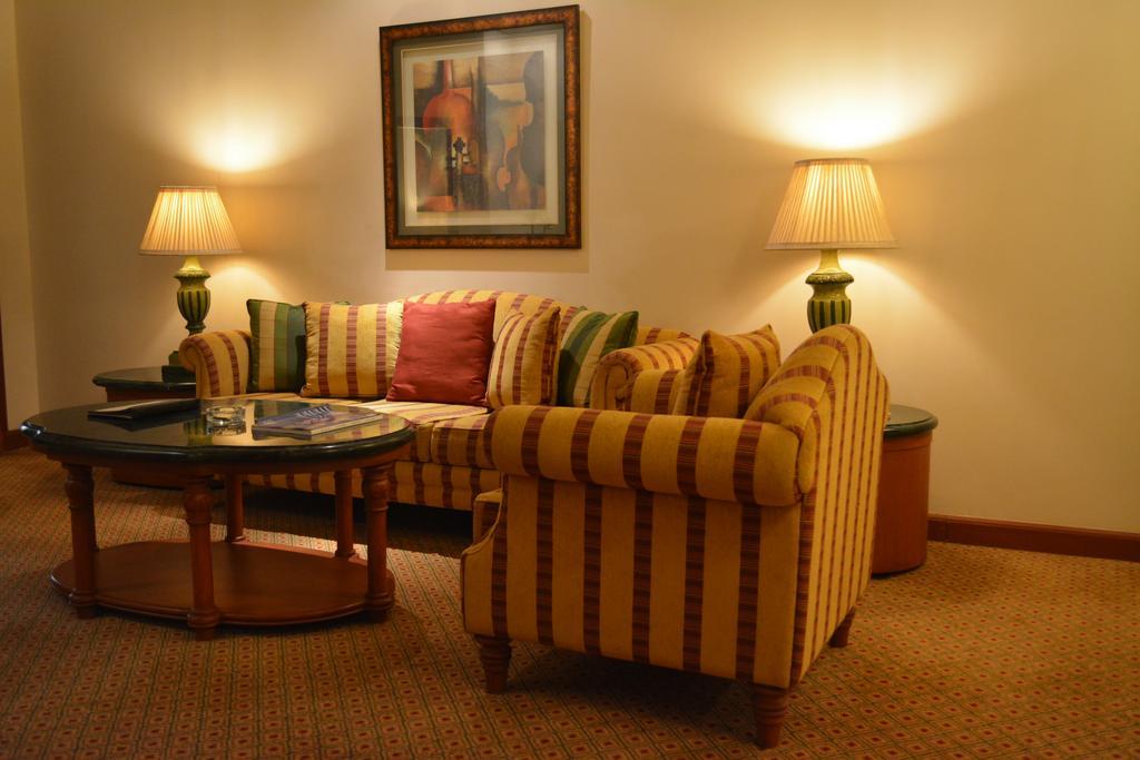 The Orchid Hotel Mumbai Vile Parle Exterior photo A living room with a sofa