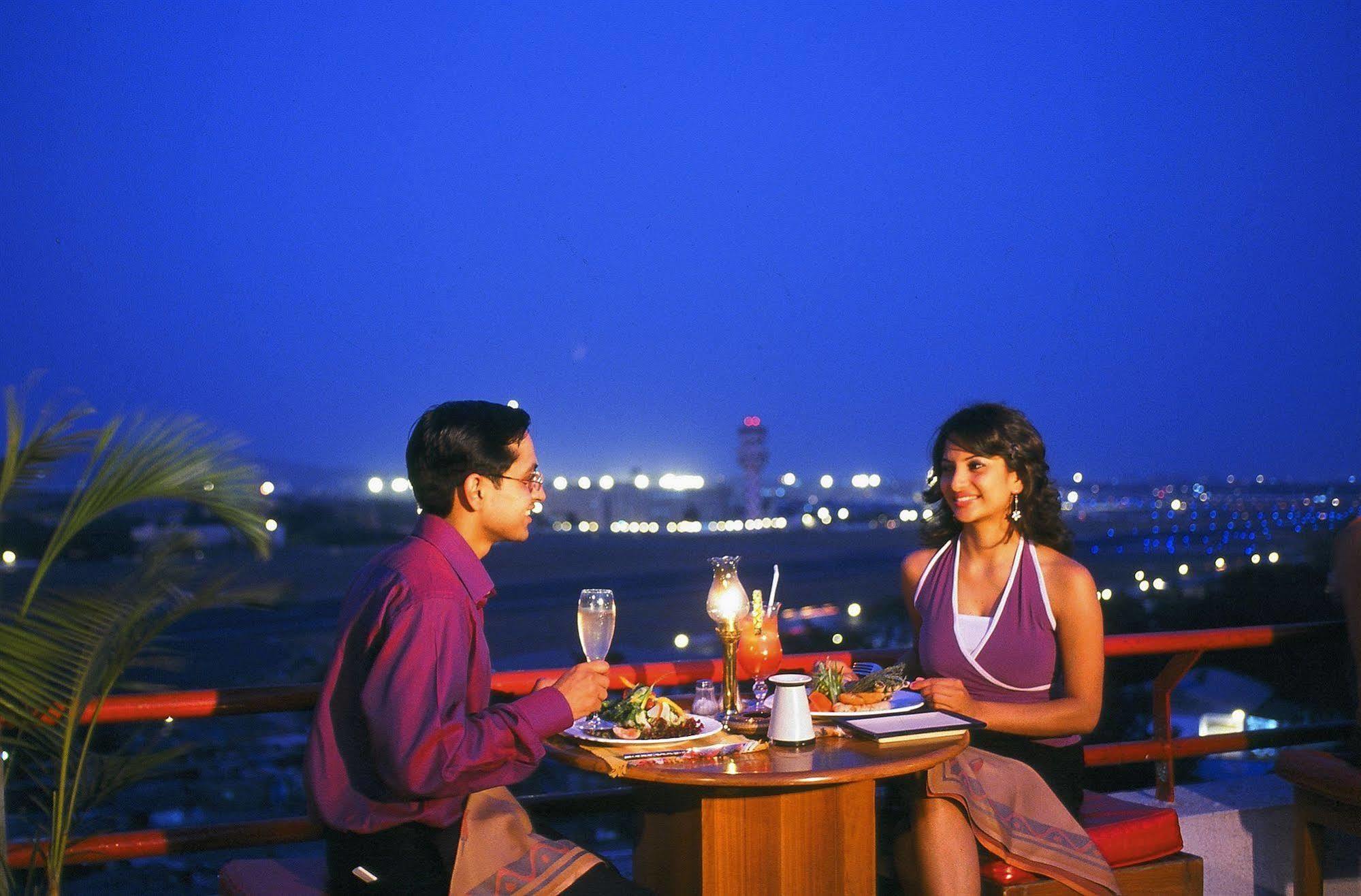 The Orchid Hotel Mumbai Vile Parle Restaurant photo A couple dining at a restaurant in India